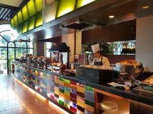 a chef is preparing food in a restaurant kitchen at Waterfront Airport Hotel and Casino in Mactan
