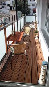 a deck with chairs and tables on a balcony at Patio 3 in Bremen