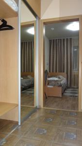 a room with two beds and a mirror at Timan Hotel in Ukhta
