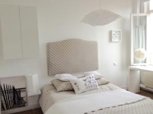 a bedroom with a bed with a polka dot headboard at La Maison de famille les Alizés in Le Crotoy