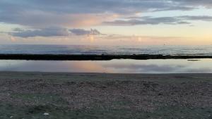 a view of the ocean with a reflection in the water at Olosuites in Limassol
