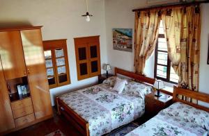 a bedroom with two beds and a window at Guest House Vasili in Berat +31 photos