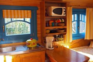 a kitchen with a counter and a sink and a window at Roulotte De Charme in Grasse