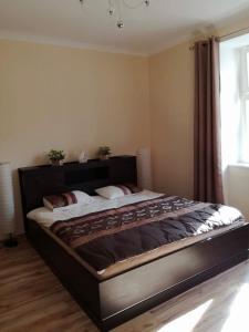 a large bed in a bedroom with a window at Gdynia Abrahama 23 in Gdynia