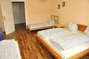 three beds in a room with wooden floors at 3-Raum-Fewo-Dresden-Altstadt-L7 in Dresden