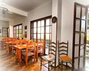 a dining room with wooden tables and chairs at Hotel Erato in Chorefto +95 photos