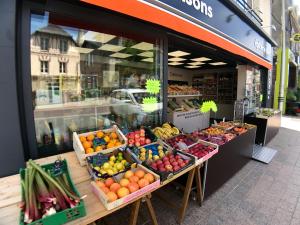 a fruit and vegetable stand in front of a store at Esprit Marine AppartHotel - Le Downtown 1 à 5 personnes in Bréhal