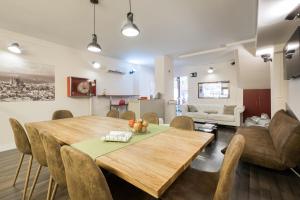 a dining room with a wooden table and chairs at Barcelona & You Hostel Sagrada Familia in Barcelona