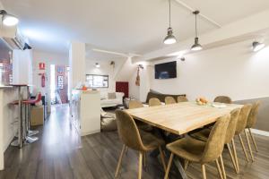a dining room and living room with a table and chairs at Barcelona & You Hostel Sagrada Familia in Barcelona