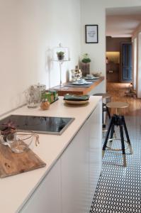 a kitchen with white cabinets and a counter top at Suite Juvara in Como