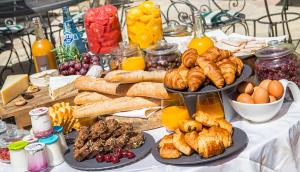 a table with many different types of bread and pastries at Le Manoir de Gressy in Gressy