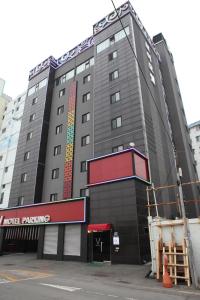 釜山的住宿－V Motel Songdo，一座大建筑,上面有标志,上面写着酒店停车场的标志