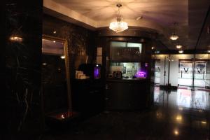 a dark room with a bar and a chandelier at V Motel Songdo in Busan +18 photos