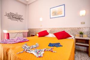 a bedroom with two dolls on a bed at Hotel Tritone Rimini in Rimini
