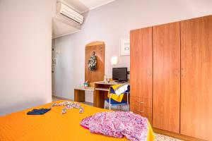 a bedroom with a bed and a desk with a computer at Hotel Tritone Rimini in Rimini