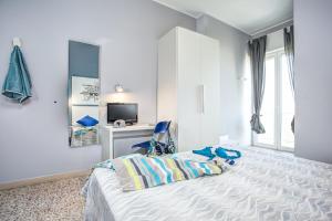 a bedroom with a bed and a desk with a computer at Hotel Tritone Rimini in Rimini