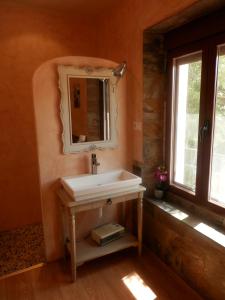 a bathroom with a sink and a mirror at La Cachumba in Ruidera
