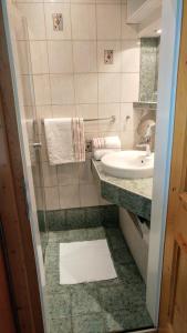 a bathroom with a sink and a toilet and a mirror at Haus Mattersberger in Matrei in Osttirol