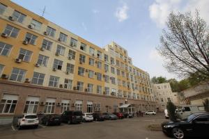 a large building with cars parked in a parking lot at Serpukhovskoy Dvor in Moscow