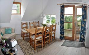 a living room with a wooden table and chairs at Danchelshus in Allinge