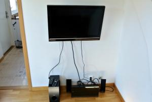 a flat screen tv hanging on a wall at Room by Water in Södertälje