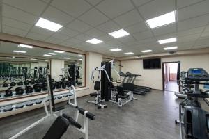 a gym with treadmills and machines in a room at Congress Hotel Forum in Ryazan