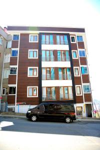 a black van parked in front of a building at Can Residence in Trabzon