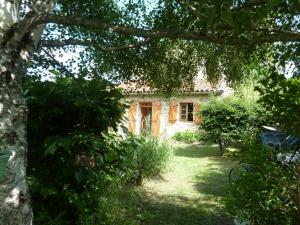 a house in the middle of a garden at Gite Le Fournial et ses animaux - 5 personnes in Pinet