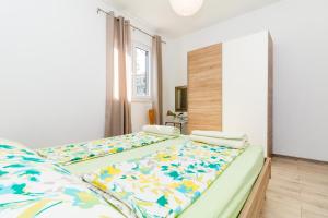 a bedroom with two beds with colorful sheets at APARTMENT JURAŠIN in Kaštela
