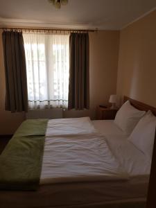 Łóżko lub łóżka w pokoju w obiekcie Villa Nina