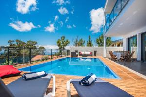 eine Villa mit Swimmingpool und ein Haus in der Unterkunft Villa Enjoy - by LovelyStay in Lombo da Velha
