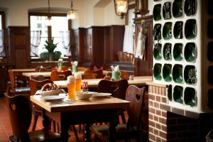 a restaurant with tables and chairs and wine bottles at Hotel zur Post in Bad Koetzting