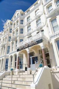 a hotel building with stairs in front of it at The Rutland Hotel in Douglas