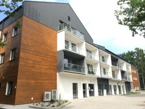 apartamentowiec z brązową i białą fasadą w obiekcie Apartament Słoneczny Dwie Sosny w mieście Ustronie Morskie