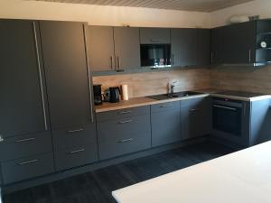 a kitchen with gray cabinets and a sink at FeWo Bettenhausen in Morschen