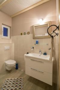 a bathroom with a sink and a toilet at Apartments Mardešić in Komiža