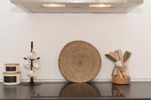 a counter top with some baskets and utensils on it at Aretousa Deluxe Downtown Apartment in Skala