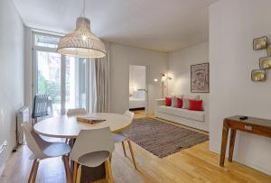 a living room with a table and chairs and a bedroom at Casas do Rivoli in Porto