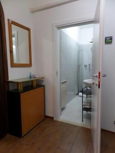 a bathroom with a sink and a shower and a mirror at Apartment Essence of Venice in Venice