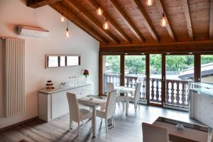a dining room with tables and chairs and a balcony at La terrazza sulle vigne B&B in Corte Franca