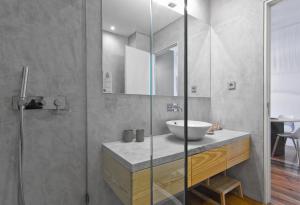 a bathroom with a sink and a glass shower at Casas do Rivoli in Porto +41 photos