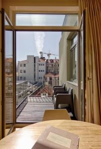 a room with a view of a city from a balcony at Casas do Rivoli in Porto
