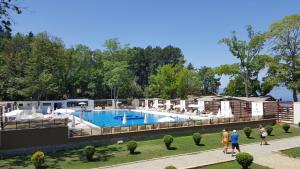 people walking around a pool at a resort at Park Beach Apartment in Ohrid