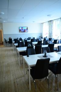 an empty room with tables and chairs in it at Alkoven Logi in Ullared
