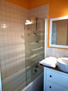 a bathroom with a shower and a sink at Le Pavillon in La Bourboule