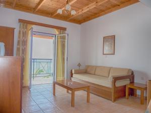 
a living room filled with furniture and a window at Maria Apartments in Agios Georgios Pagon
