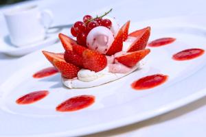 a dessert with strawberries and ice cream on a plate at Le Manoir de Gressy in Gressy +42 photos