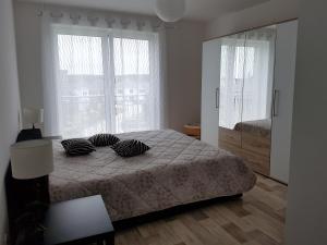a bedroom with a bed with two pillows on it at Apartment by Janzen in Rheine