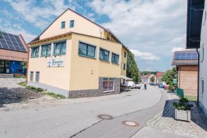 une maison avec des panneaux solaires sur le côté d'une rue dans l'établissement Gasthof Metzgerei Linsmeier, à Iggensbach