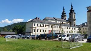 a large building with cars parked in a parking lot at JUFA Hotel Spital am Pyhrn in Spital am Pyhrn